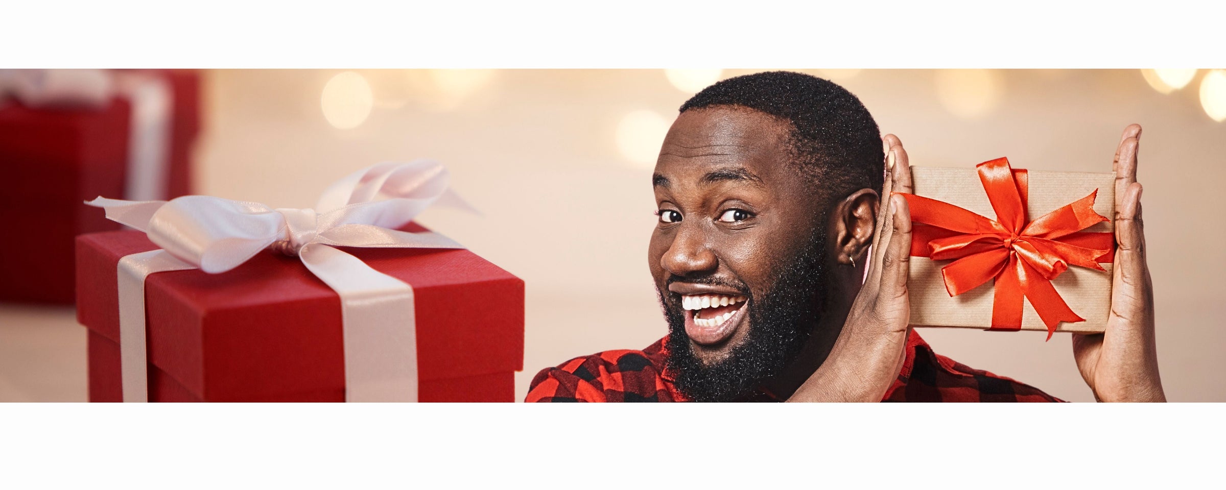Gift Ideas for Men banner featuring a man holding a gift with more wrapped gifts in the background