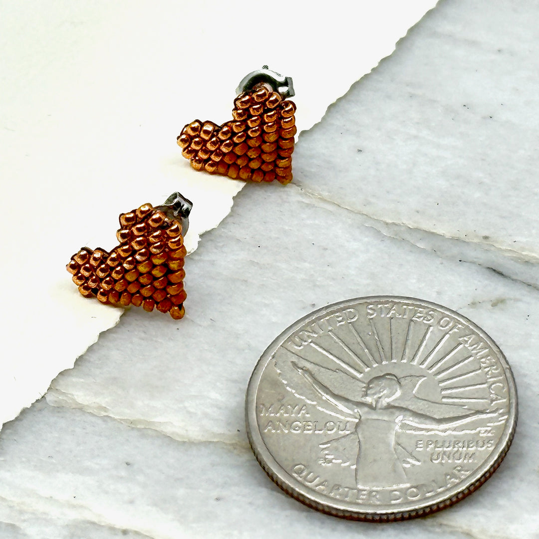 Pair of Heart Beaded Earrings with Stainless Steel Studs, handmade in Montana USA by Aurum Shimmer (copper and tan), with scale