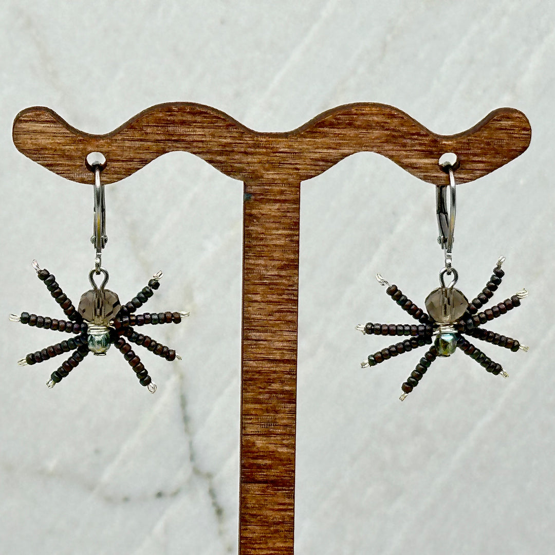 Pair of grey Spider Beaded Earrings with Stainless Steel Lever Backs, handmade in Montana USA by Aurum Shimmer, hanging