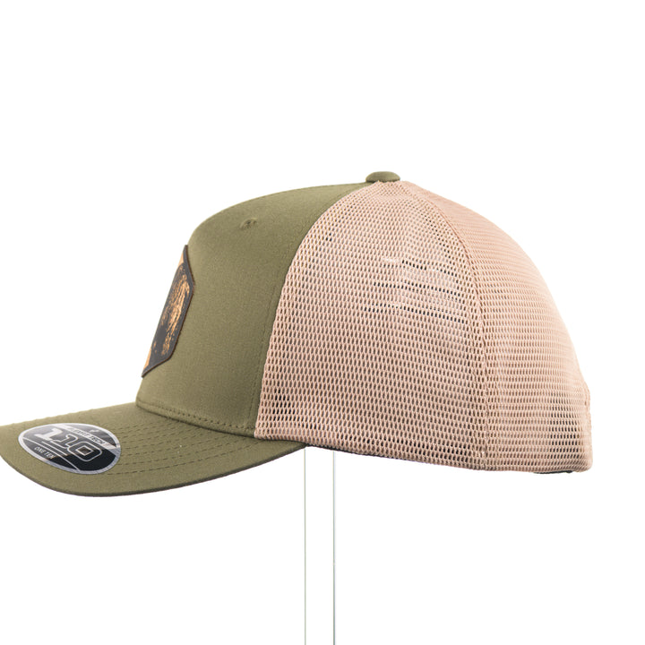 The side of an olive green and khaki mesh flexfit trucker hat with a bison flexwood hexagon patch.