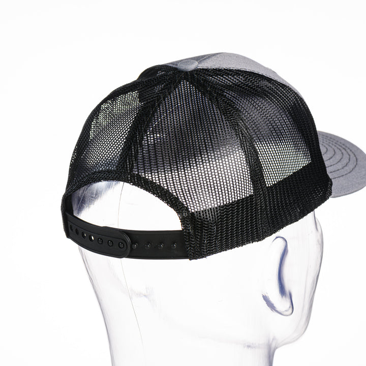 Back of a grey and black Cats Montana Youth Snapback Trucker Hat made in Montana (home of the MSU Cats) by Blue Peak Creative—a grey and black youth trucker hat embroidered with a white Cats script over a blue Montana state silhouette, outlined in white