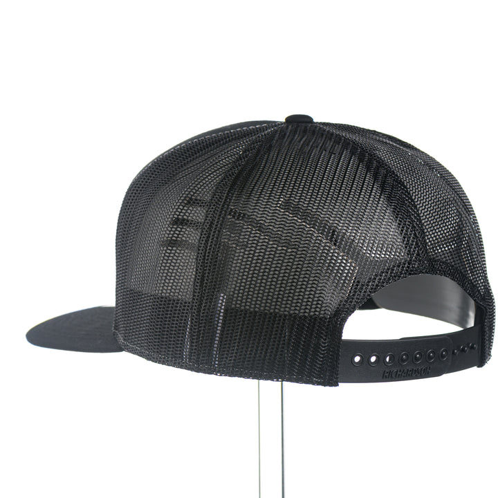 Black mesh cap  with a leather University of Montana Griz Script on a white background