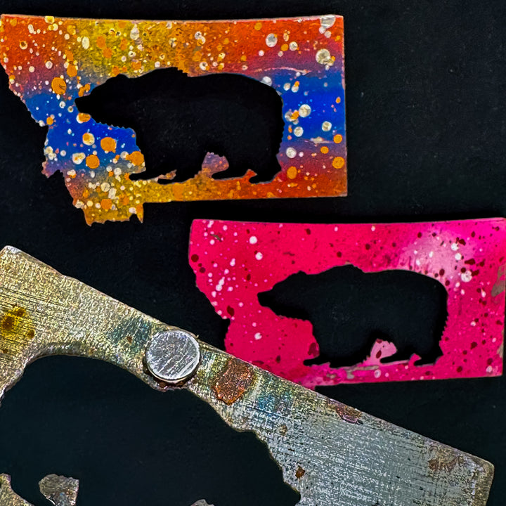 A made in Montana state-shaped cut-out with a bear silhouette embedded in it and a strong back magnet.