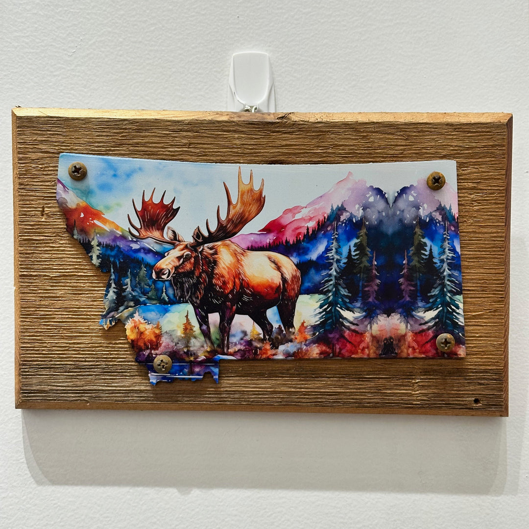 This Metal and wood plaque is in the shape of Montana with a vibrant print of a Moose. Made in Montana.