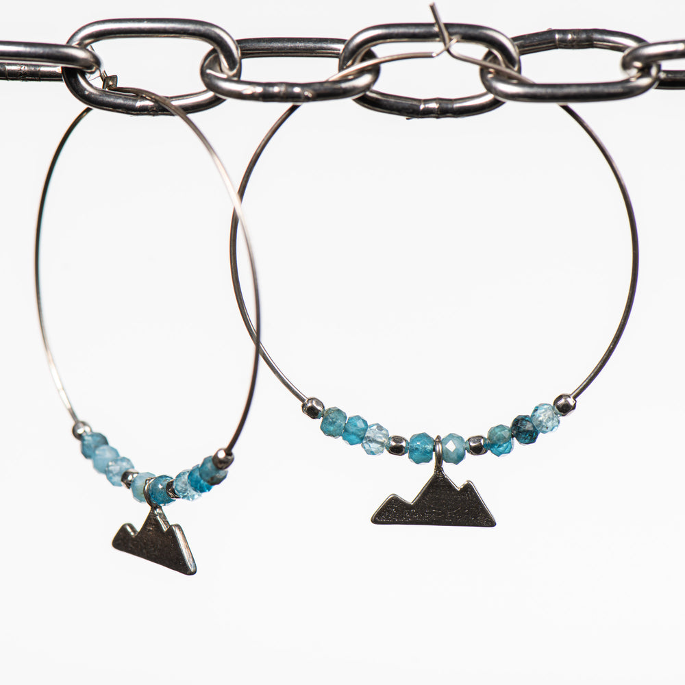 Cobblestone Design of Montana's Hoop Earrings, handcrafted earrings made in Montana featuring a sterling silver mountain dangle and apatite beads