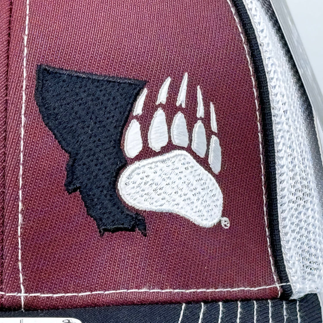 Blue Peak Creative's maroon, black, and white Trucker Pacflex Hat embroidered with the Montana Grizzlies Paw design in black and white (detail)
