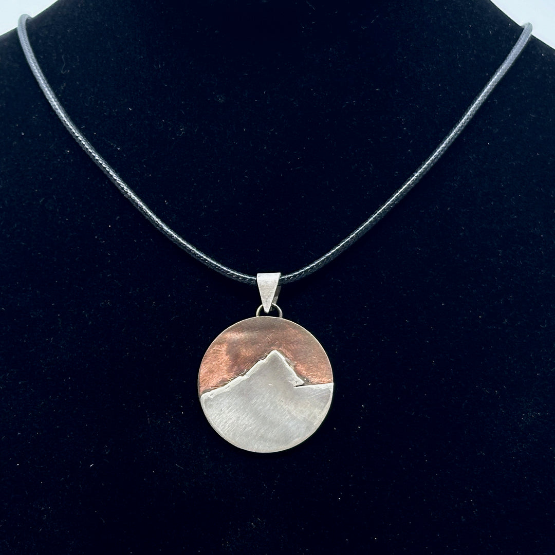 Bull & Bear's Copper and .925 Sterling Silver Montana Mountain Pendant, featuring Ch-paa-qn Peak, on a black cord