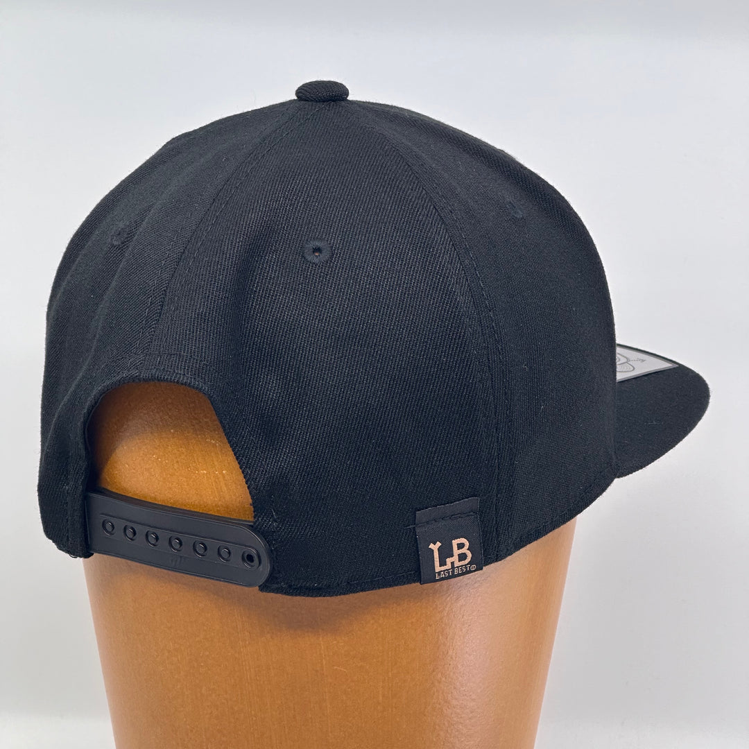 Black flat bill hat featuring the 2024 Missoula PRIDE design Pride is Prevention, back