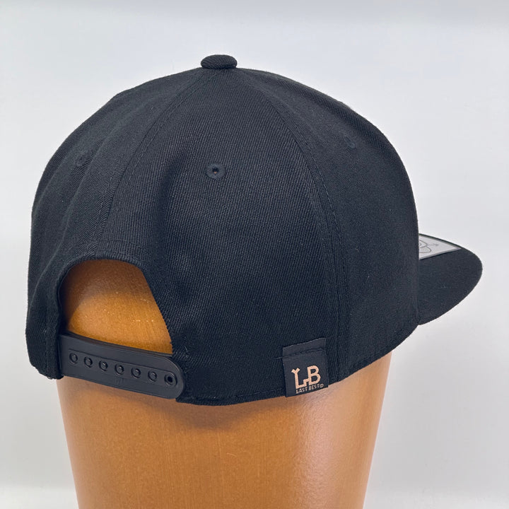 Black flat bill hat featuring the 2024 Missoula PRIDE design Pride is Prevention, back