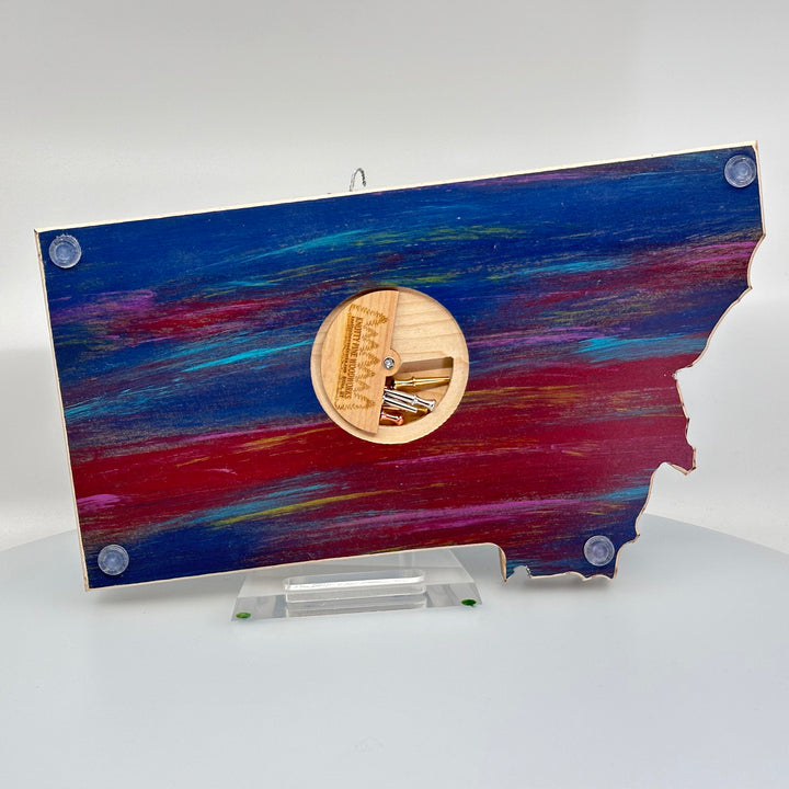 Knotty Pine Woodworks Handmade Montana Sasquatch Cribbage Board Sunset (back)—this handmade wooden cribbage board is the perfect Montana-made gift for game lovers and adventurers. The back features a compartment for storing metal pegs.