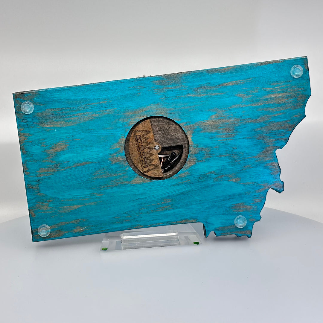 Knotty Pine Woodworks Handmade Montana Trout Cribbage Board Turquoise (back)—this handmade wooden cribbage board is the perfect Montana-made gift for game lovers and fishers. The back features a compartment for storing metal pegs.