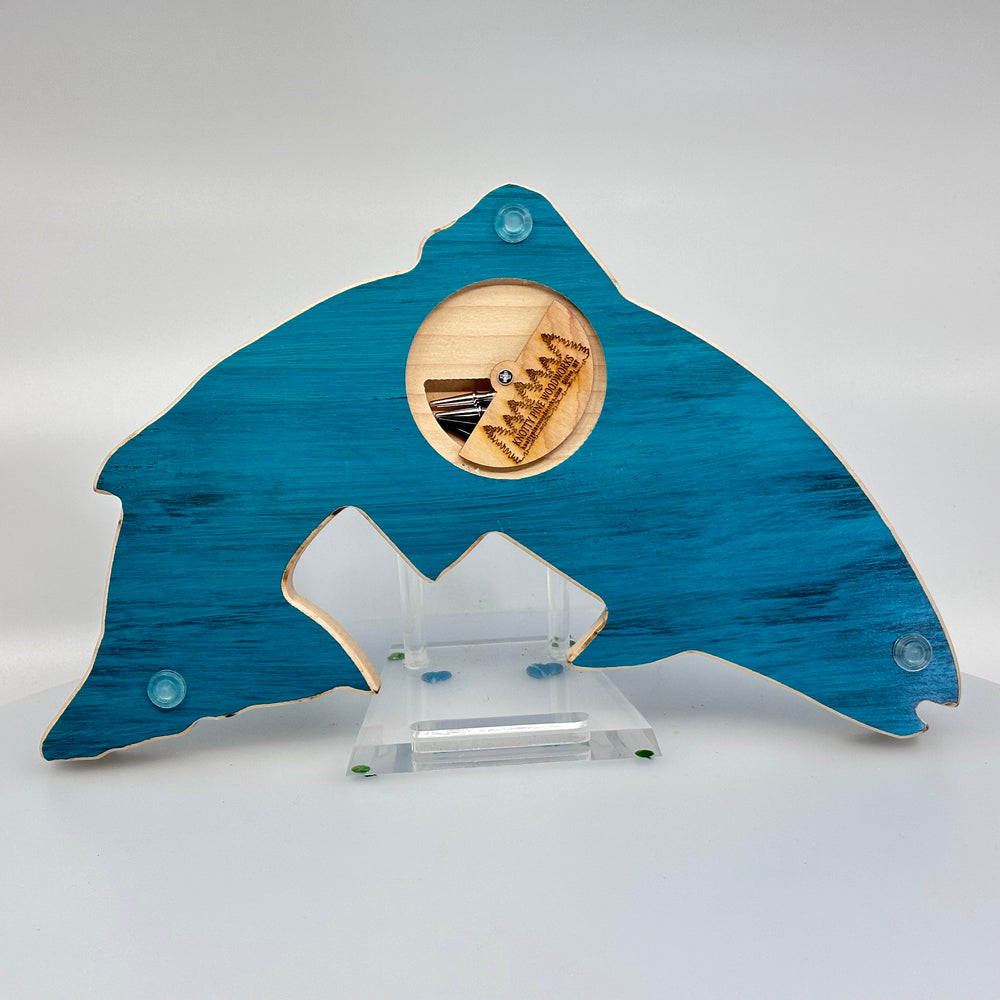 Knotty Pine Woodworks Handmade Trout Cribbage Board with Montana Mountain Scene Turquoise (back)—this handmade wooden cribbage board is the perfect Montana-made gift for game lovers and fishers. The back features a compartment for storing metal pegs.