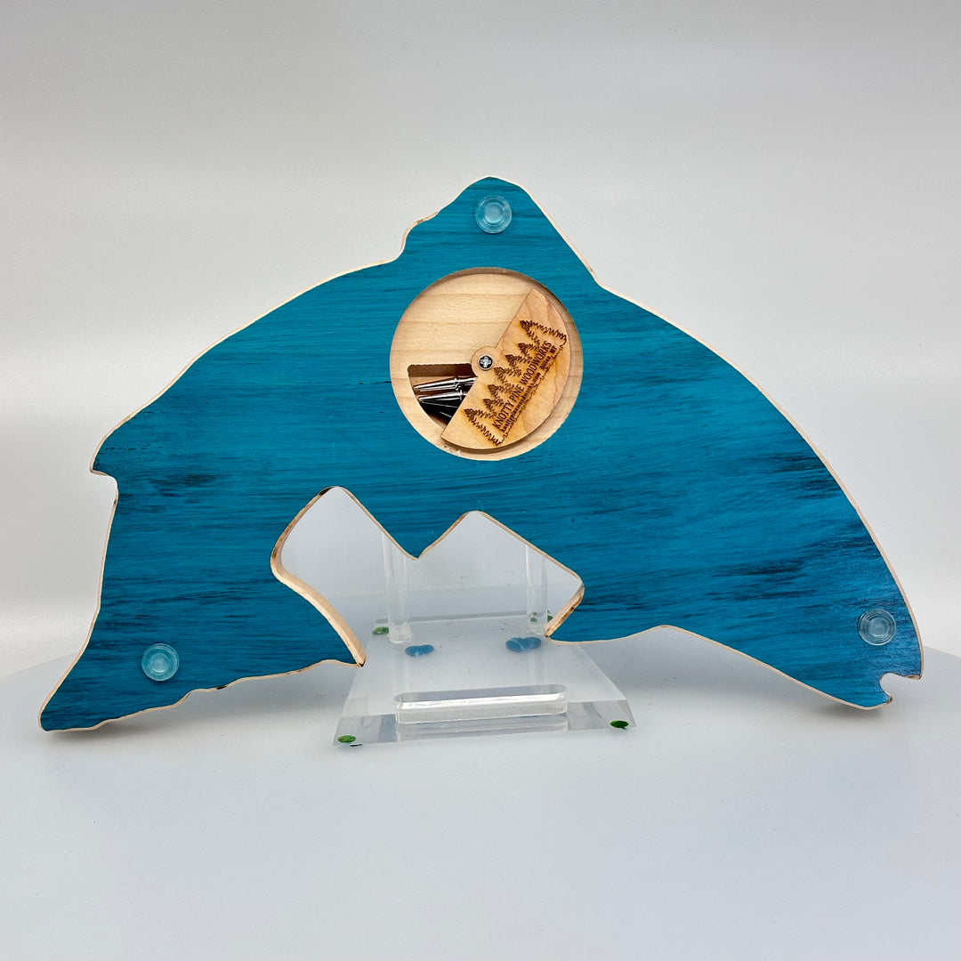 Knotty Pine Woodworks Handmade Trout Cribbage Board with Montana Mountain Scene Turquoise (back)—this handmade wooden cribbage board is the perfect Montana-made gift for game lovers and fishers. The back features a compartment for storing metal pegs.