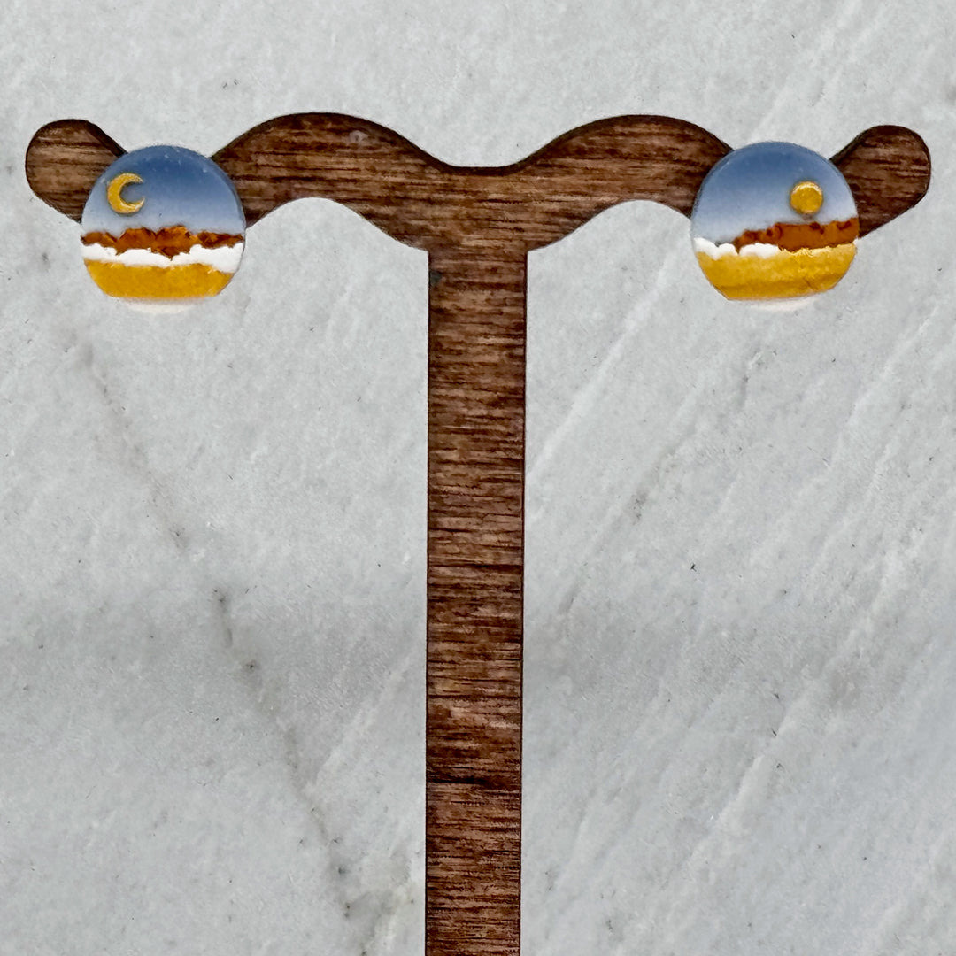 Pair of La Petite Rose's Sun Moon Landscape Clay Stud Earrings (blue and gold), hanging