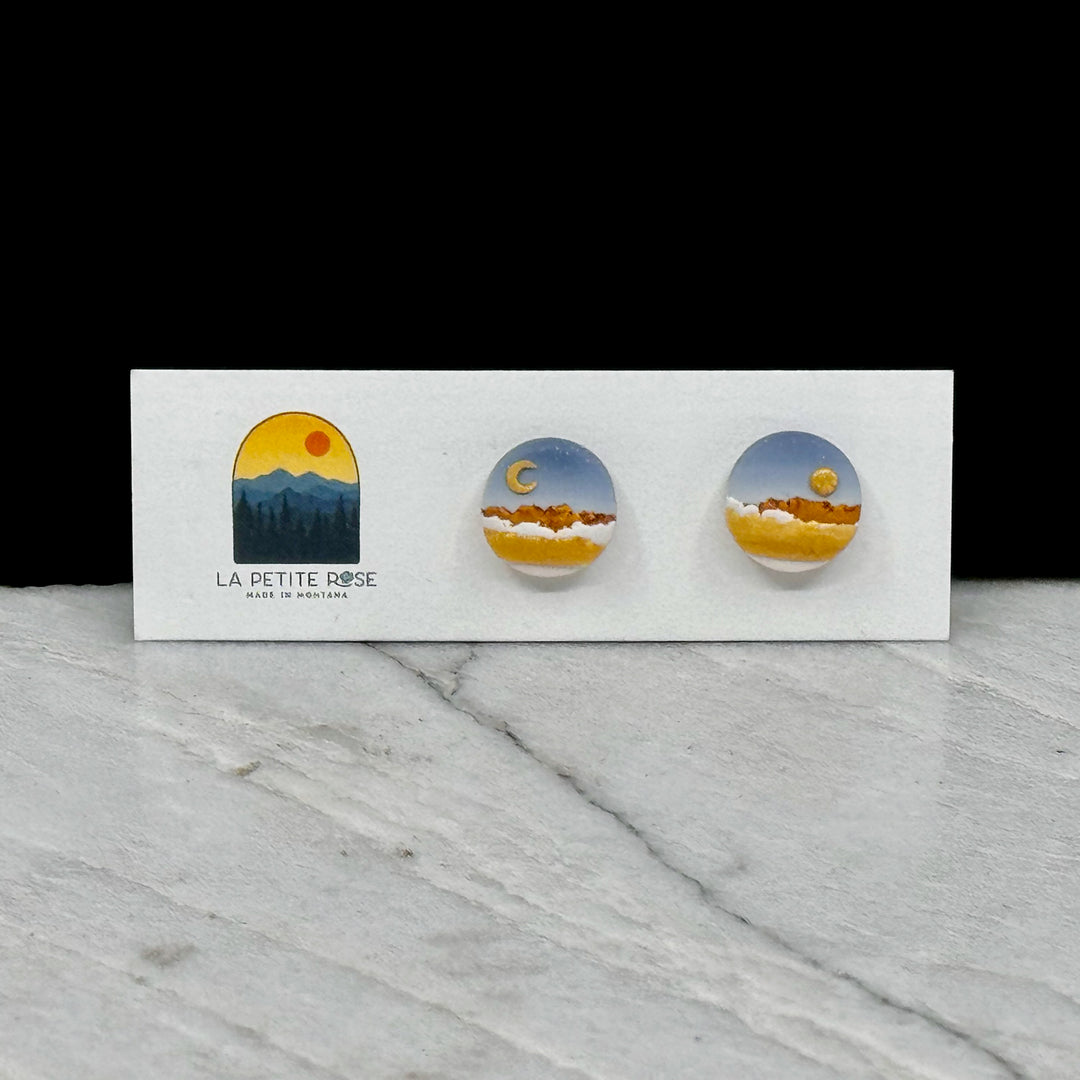 Sun Moon Landscape Clay Stud Earrings by La Petite Rose -  polymer clay stud earrings featuring a paired sun and moon over a colorful landscape (blue and gold)