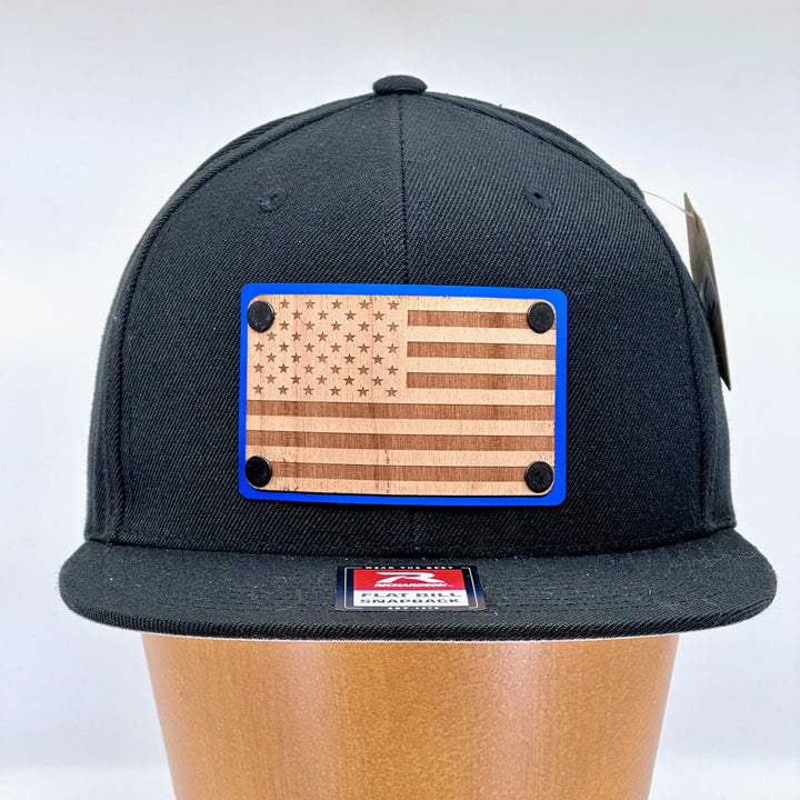 American Flag Wood & Blue Anodized Aluminum Plate Richardson Flat Bill Hat featuring an American Flag etched on alder wood veneer and laminated to a blue anodized aluminum plate—handmade in Montana, USA by Last Best Supply Co.