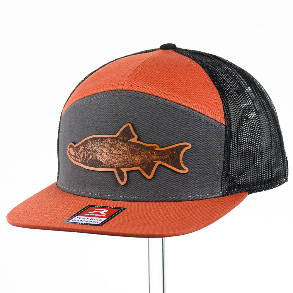 Etched Leather Chinook Salmon Patch Flat Bill Trucker Hat, featuring a real leather patch cut into the shape of a Chinook Salmon and etched with detail, securely attached to an orange and grey trucker hat—handmade in Montana, USA by Last Best Supply Co.
