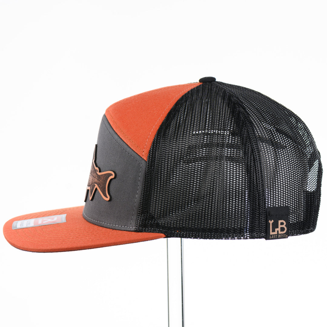 Etched Leather Chinook Salmon Patch Flat Bill Trucker Hat, featuring a real leather patch cut into the shape of a Chinook Salmon and etched with detail, securely attached to an orange and grey trucker hat—handmade in Montana, USA by Last Best Supply Co.
