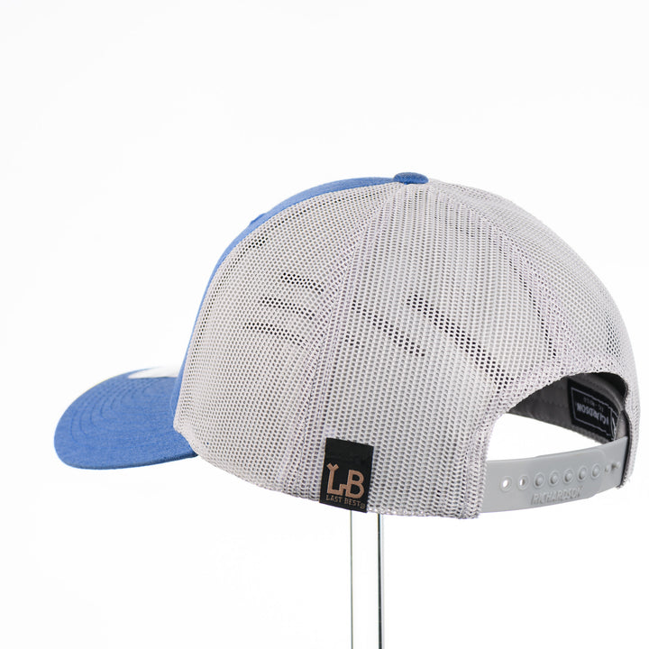 Etched Leather Fish Trucker Hat, featuring a real leather patch cut into the shape of a fish and etched with detail, securely attached to a blue and white trucker hat—handmade in Montana, USA by Last Best Supply Co.