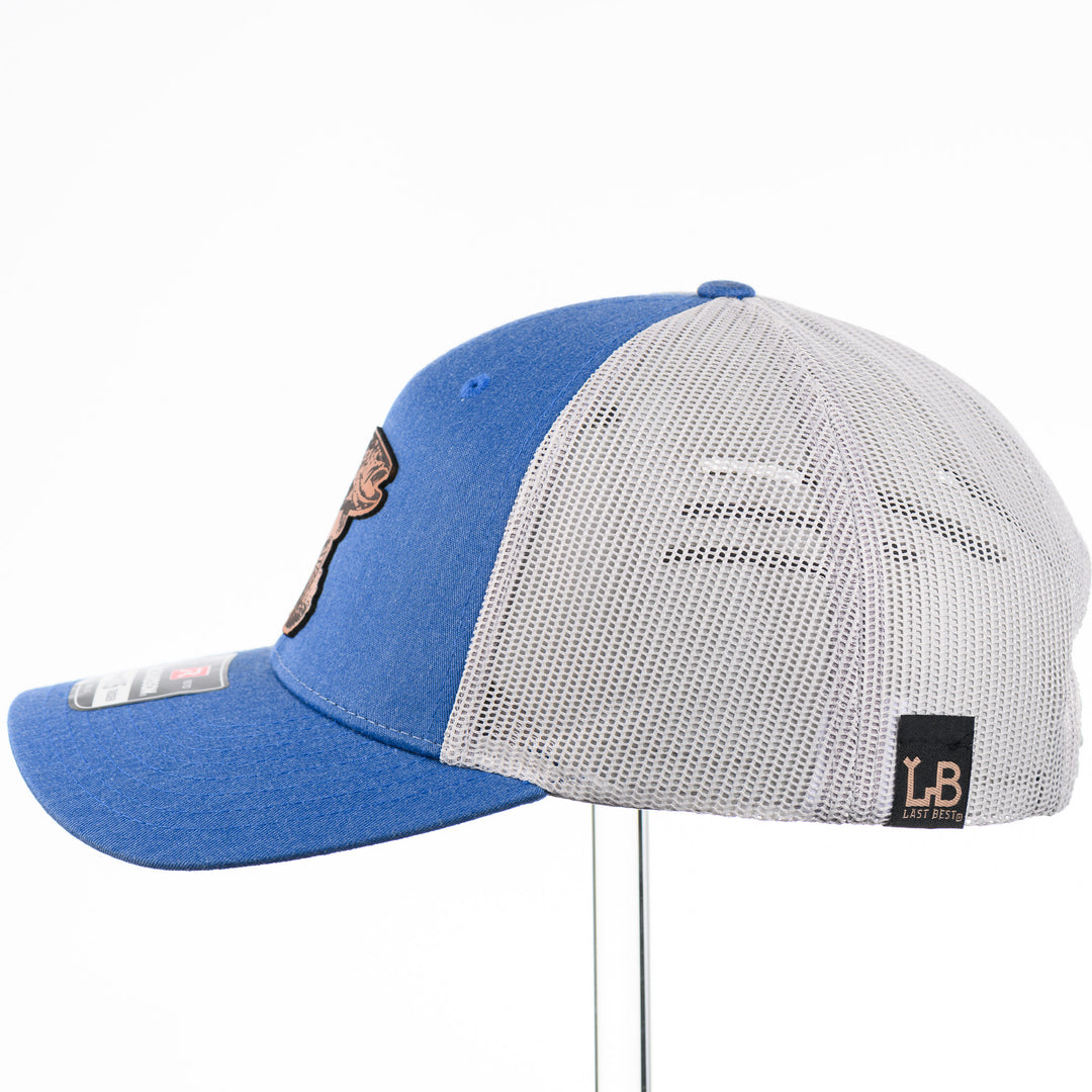 Etched Leather Fish Trucker Hat, featuring a real leather patch cut into the shape of a fish and etched with detail, securely attached to a blue and white trucker hat—handmade in Montana, USA by Last Best Supply Co.