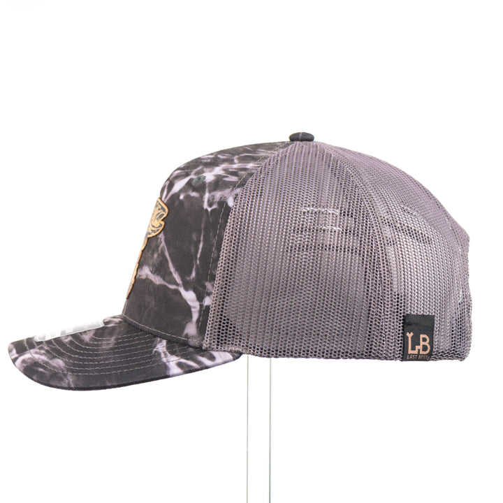 Flexwood Jumping Trout Richardson Trucker Cap featuring a premium flexwood patch in the shape of a jumping trout, handmade in Montana, USA by Last Best Supply Co.