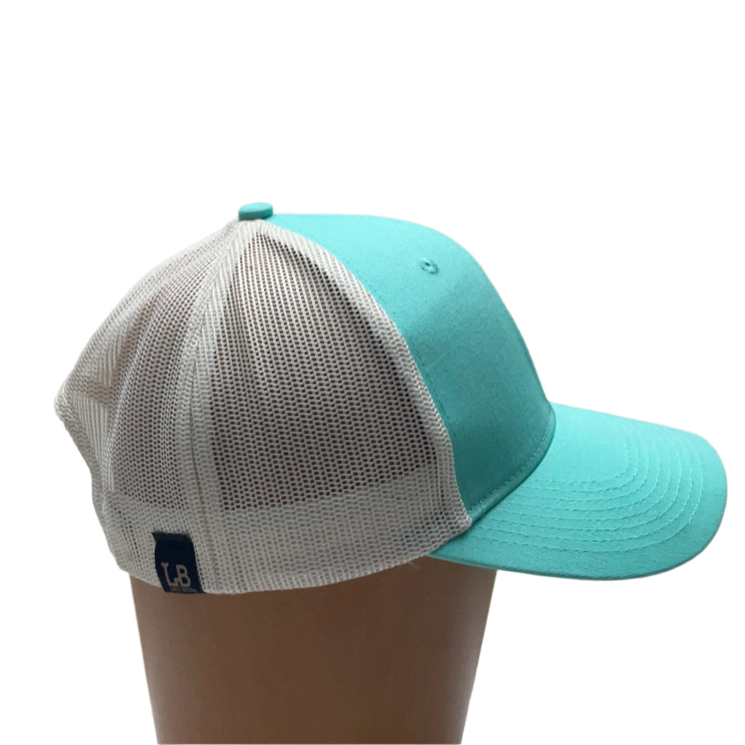 Premium Leather Montana Bear on Low Profile Teal Trucker Hat, featuring a blue hand-dyed leather patch cut in the shape of the state of Montana with a grizzly bear cut-out, heat pressed to the structured front of a teal and white  trucker hat—handmade in Montana, USA by Last Best Supply Co.