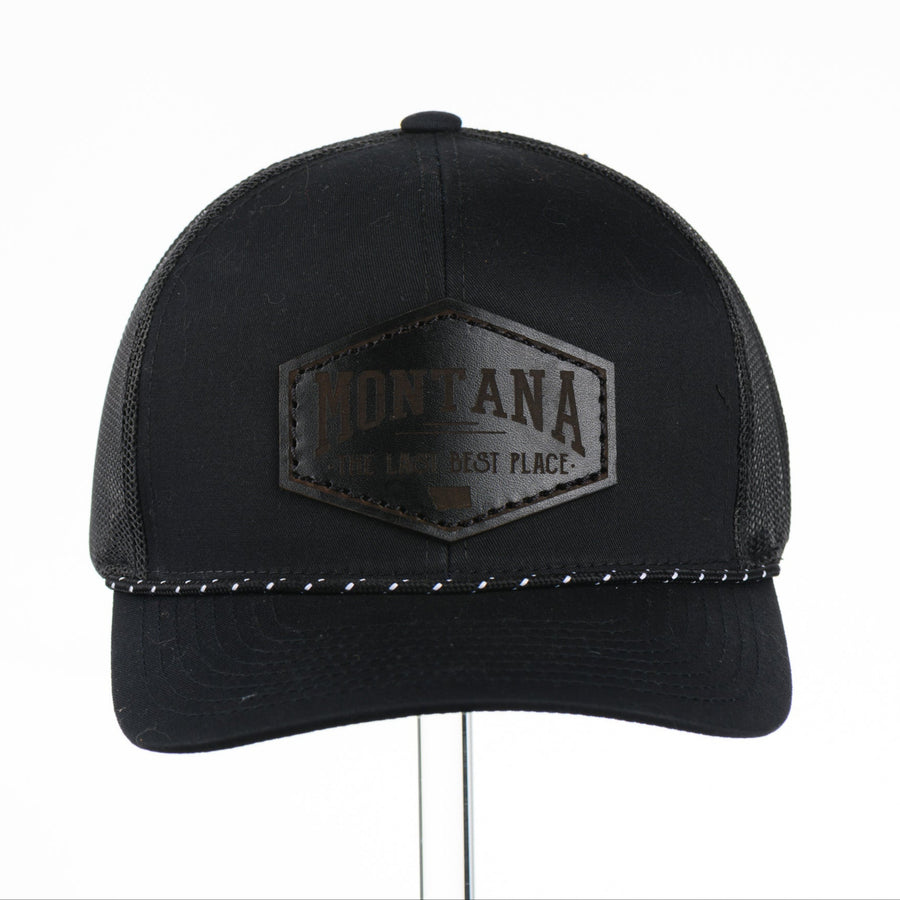 Black trucker cap with Montana The Last Best Place Leather Patch logo on a white background