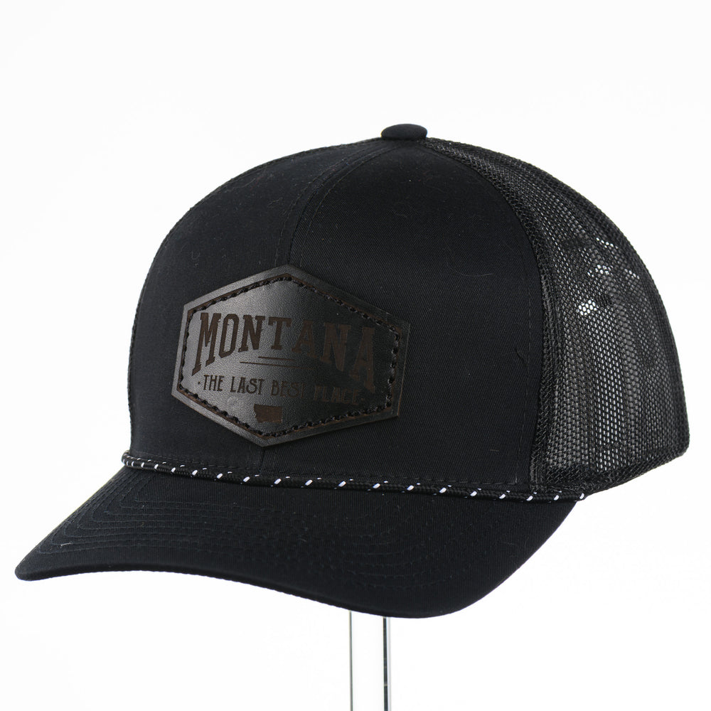 Black trucker cap with 'Montana The Last Best Place' Leather Patch logo on a white background