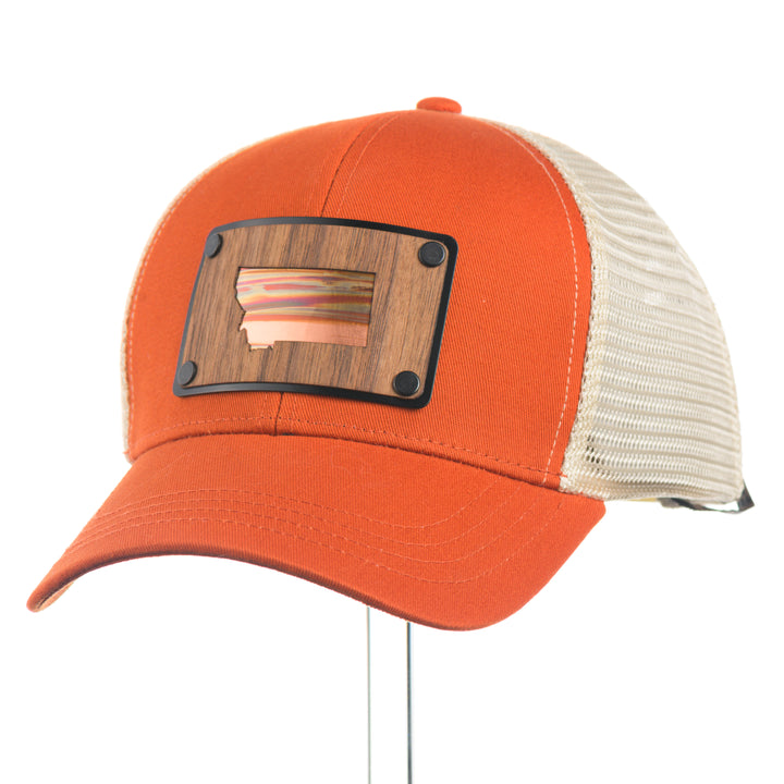 Orange and beige trucker cap with wood and copper patch on a white background