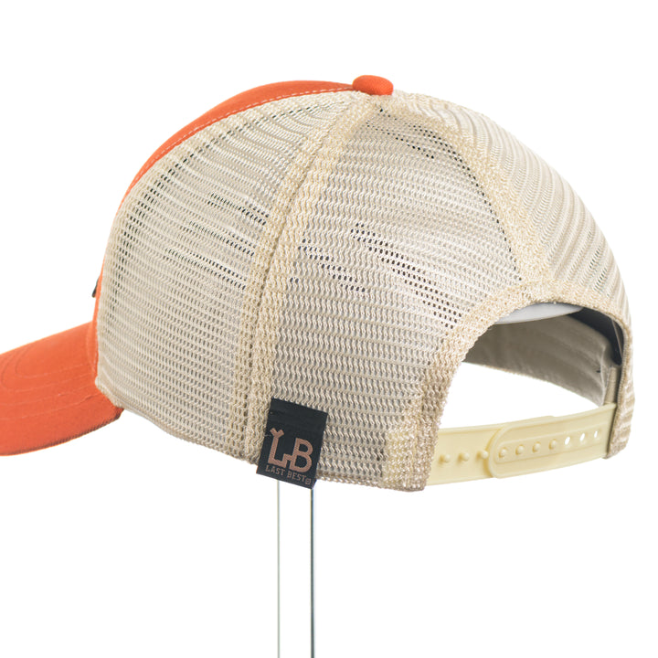 Trucker cap with orange visor and beige mesh back on a white background