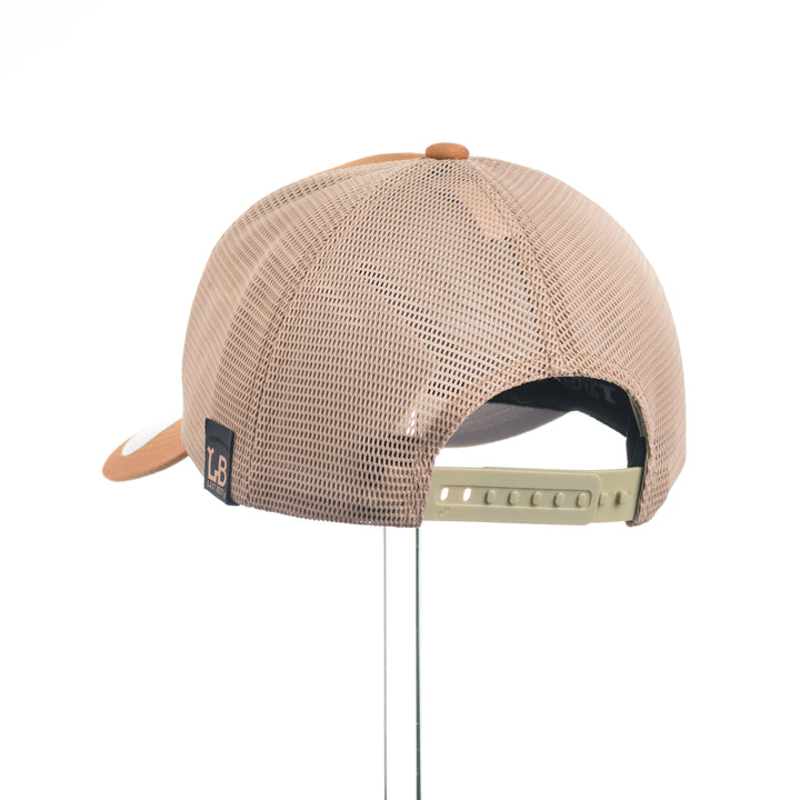 Beige mesh cap with an elk and MT leather patch logo on a white background