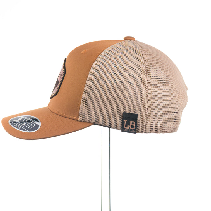 Brown and beige trucker cap with elk and MT leather patch and mesh back on a white background