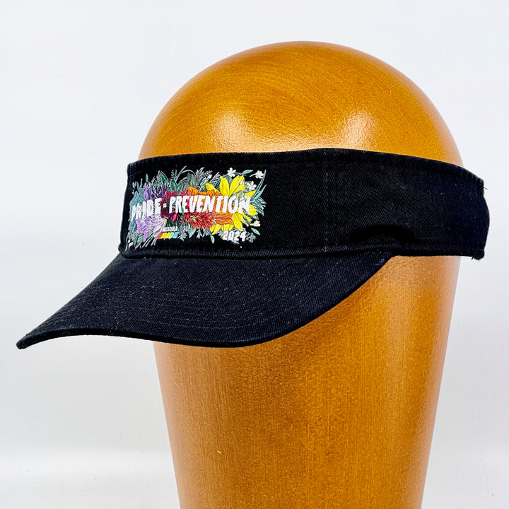Black visor featuring the 2024 Missoula Pride design Pride is Prevention design; a portion of sales are donated to the Missoula Pride fundraiser.