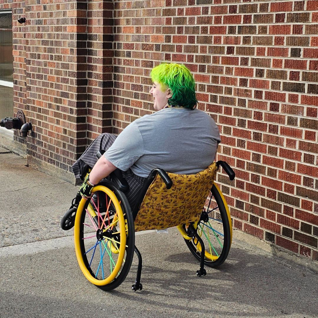 Grey all-gender / unisex t-shirt featuring the Missoula PRIDE logo made in Montana, USA; a portion of sales are donated to the Missoula Pride fundraiser.