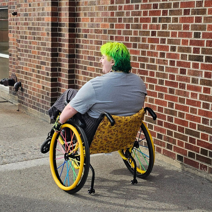 Grey all-gender / unisex t-shirt featuring the Missoula PRIDE logo made in Montana, USA; a portion of sales are donated to the Missoula Pride fundraiser.