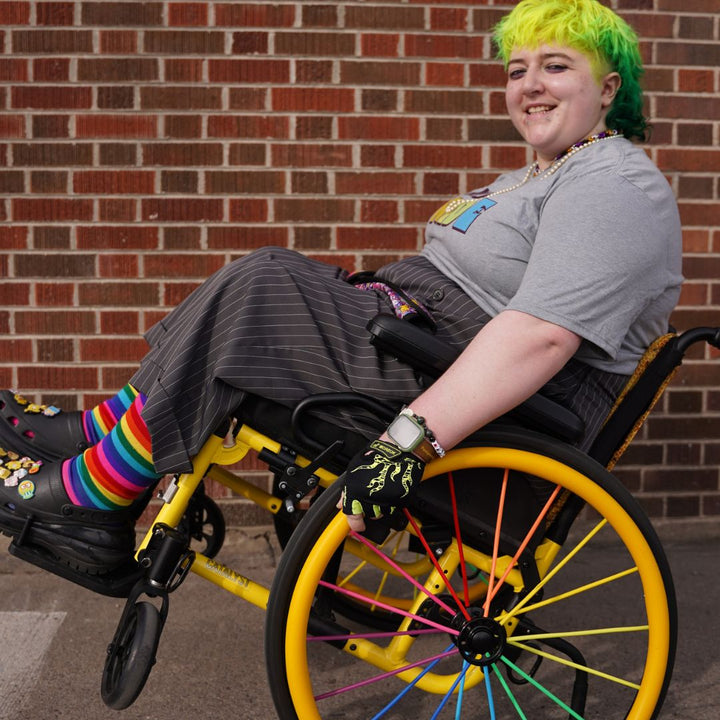 Grey all-gender / unisex t-shirt featuring the Missoula PRIDE logo made in Montana, USA; a portion of sales are donated to the Missoula Pride fundraiser.