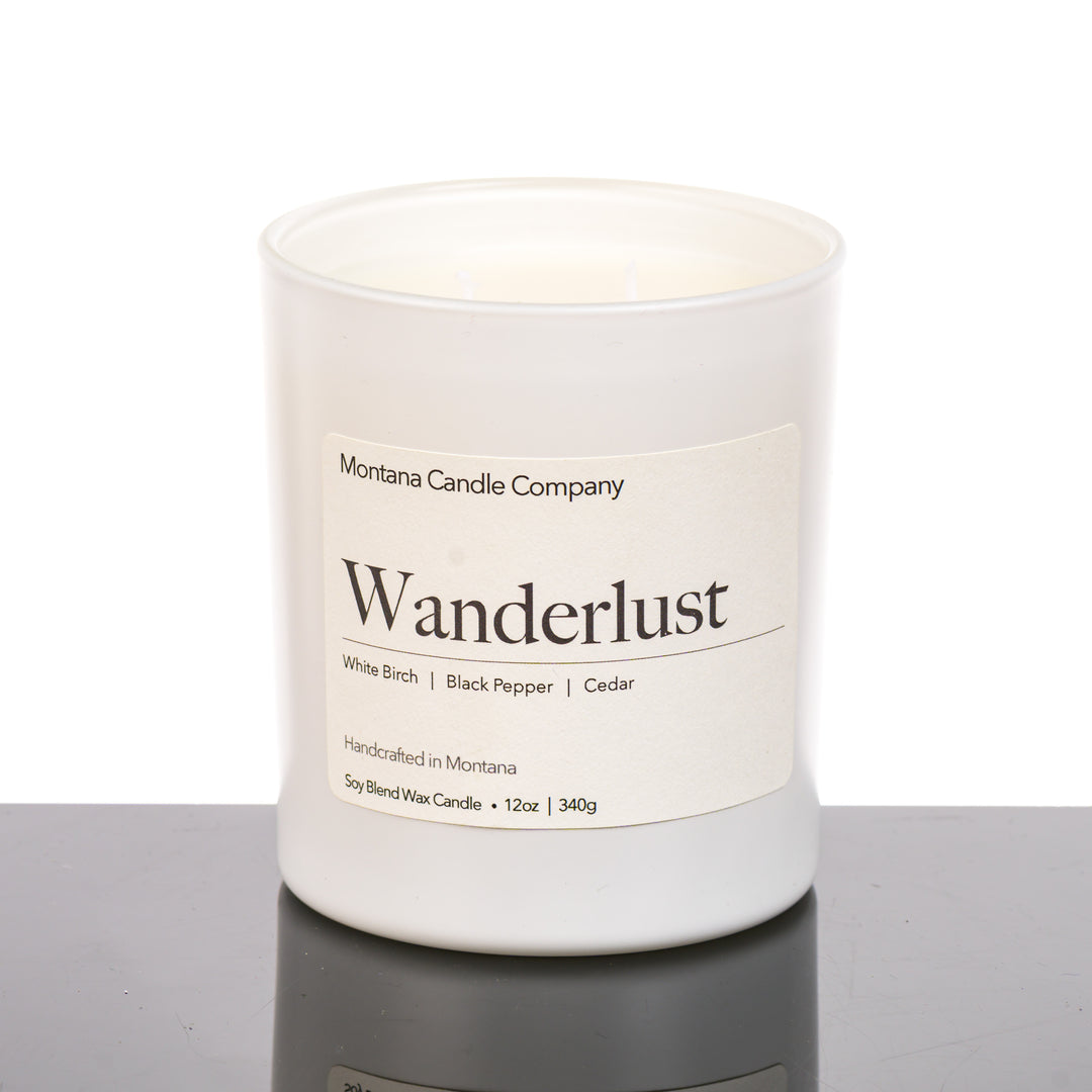 Wanderlust Candle soy blend candle handmade in Missoula, Montana by Montana Candle Company, scented with a white birch, black pepper, and cedar, 12 oz. glass tumbler
