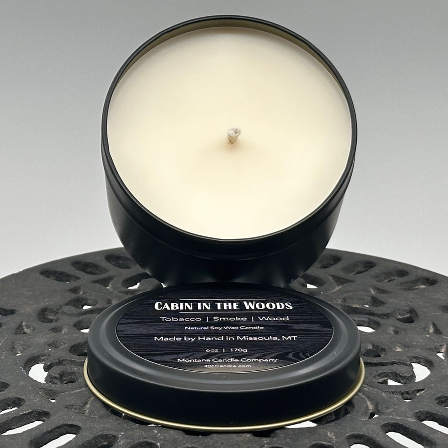 Cabin in the Woods Candle handmade in Missoula, Montana by Montana Candle Company, with a blend of tobacco, smoke, and wood scents, in a 6 oz. tin