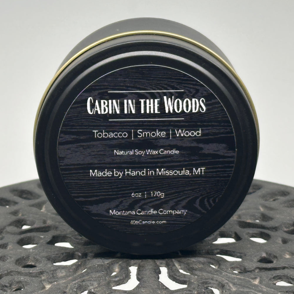 Cabin in the Woods Candle handmade in Missoula, Montana by Montana Candle Company, with a blend of tobacco, smoke, and wood scents, in a 6 oz. tin