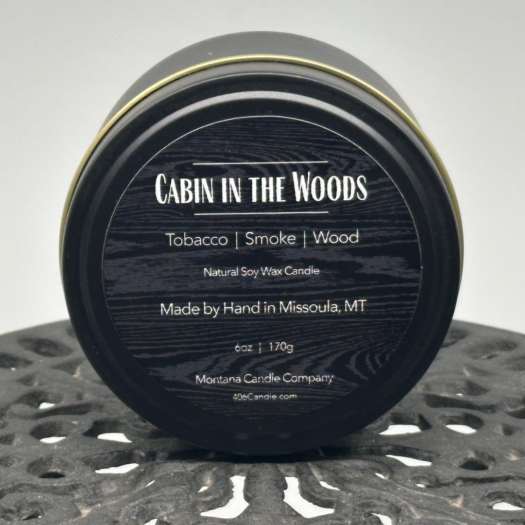 Cabin in the Woods Candle handmade in Missoula, Montana by Montana Candle Company, with a blend of tobacco, smoke, and wood scents, in a 6 oz. tin