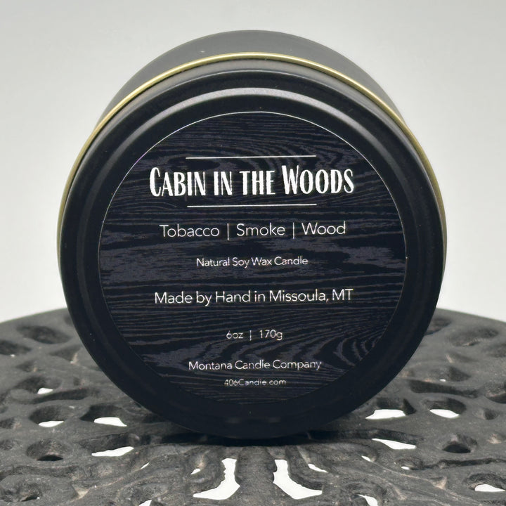 Cabin in the Woods Candle handmade in Missoula, Montana by Montana Candle Company, with a blend of tobacco, smoke, and wood scents, in a 6 oz. tin
