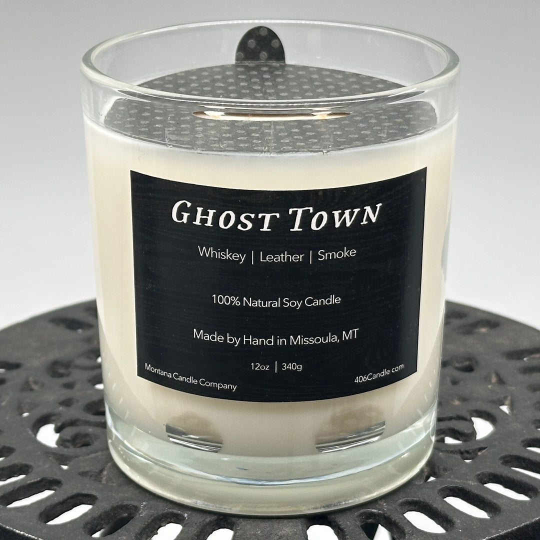Ghost Town Candle soy blend candle handmade in Missoula, Montana by Montana Candle Company, with a blend of whiskey, leather, and smoke scents, in a 12 oz. glass tumbler