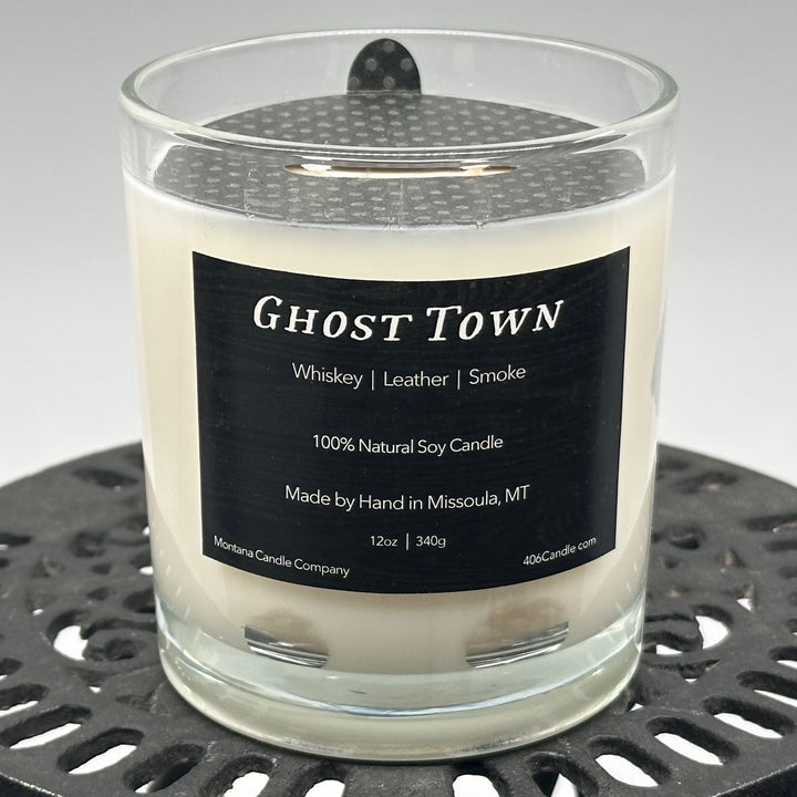 Ghost Town Candle soy blend candle handmade in Missoula, Montana by Montana Candle Company, with a blend of whiskey, leather, and smoke scents, in a 12 oz. glass tumbler