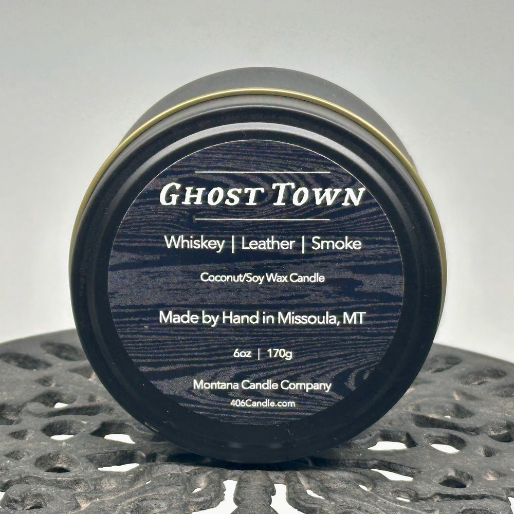 Ghost Town Candle soy blend candle handmade in Missoula, Montana by Montana Candle Company, with a blend of whiskey, leather, and smoke scents, in a 5 oz. tin, 6 oz. tin, 9 oz. glass tumbler, or 12 oz. glass tumbler