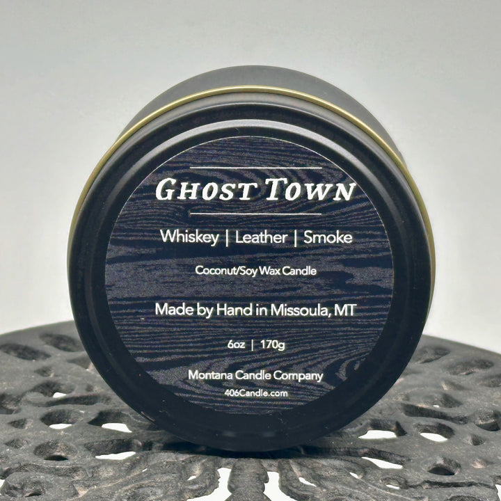 Ghost Town Candle soy blend candle handmade in Missoula, Montana by Montana Candle Company, with a blend of whiskey, leather, and smoke scents, in a 5 oz. tin, 6 oz. tin, 9 oz. glass tumbler, or 12 oz. glass tumbler