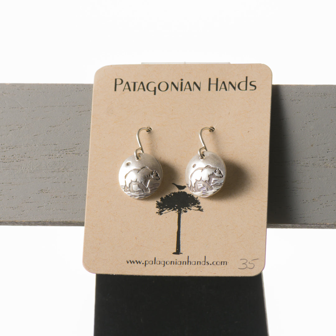 Handmade fine silver earrings featuring a bear made by Patagonian Hands in Missoula, Montana.