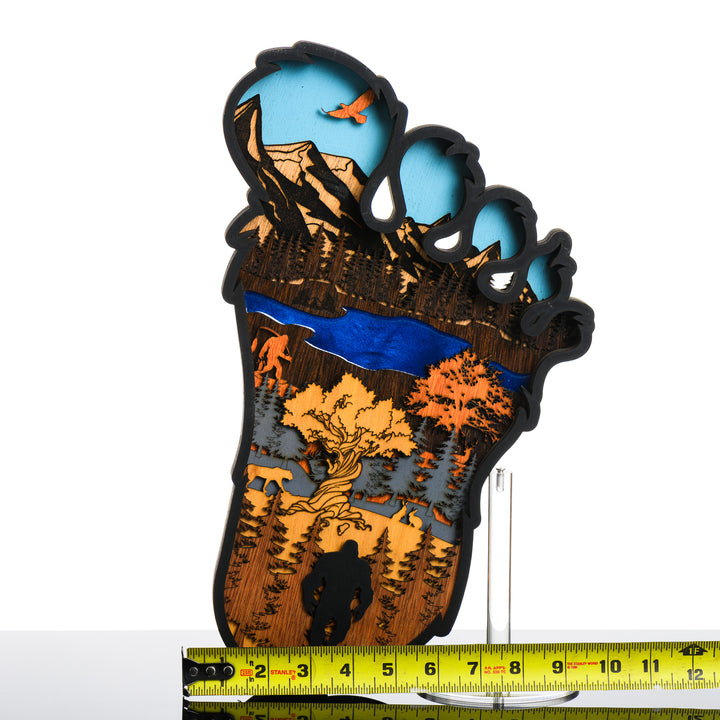 Bigfoot 3D Layered Wood Artmade in Montana by RJS Engraving & Design - laser-cut wood art depicting a wilderness scene inside the silhouette of a Bigfoot foot, Large with scale