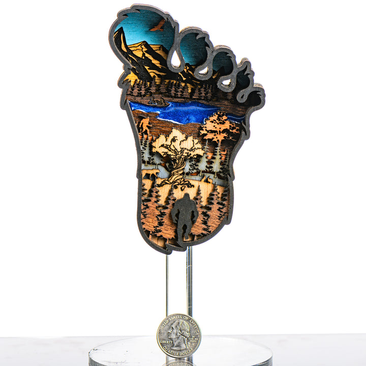Bigfoot 3D Layered Wood Artmade in Montana by RJS Engraving & Design - laser-cut wood art depicting a wilderness scene inside the silhouette of a Bigfoot foot, Mini with scale