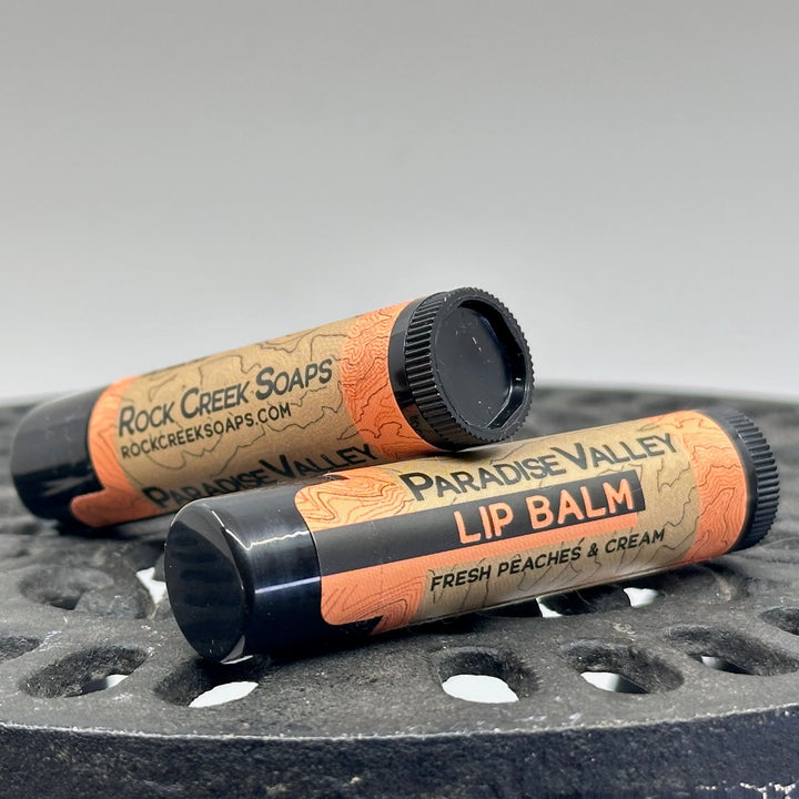 .15 oz. tube of Nourishing Natural Lip Balm, made in Montana by Rock Creek Soaps, available in assorted natural flavors - Paradise Valley (fresh peaches & cream)