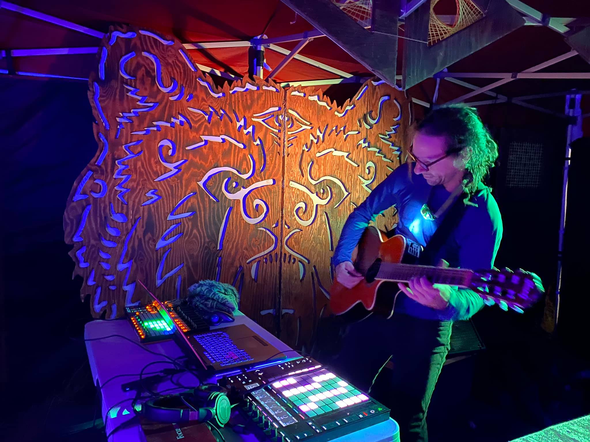 Photograph of a musician playing guitar at a Starlight Reunion event
